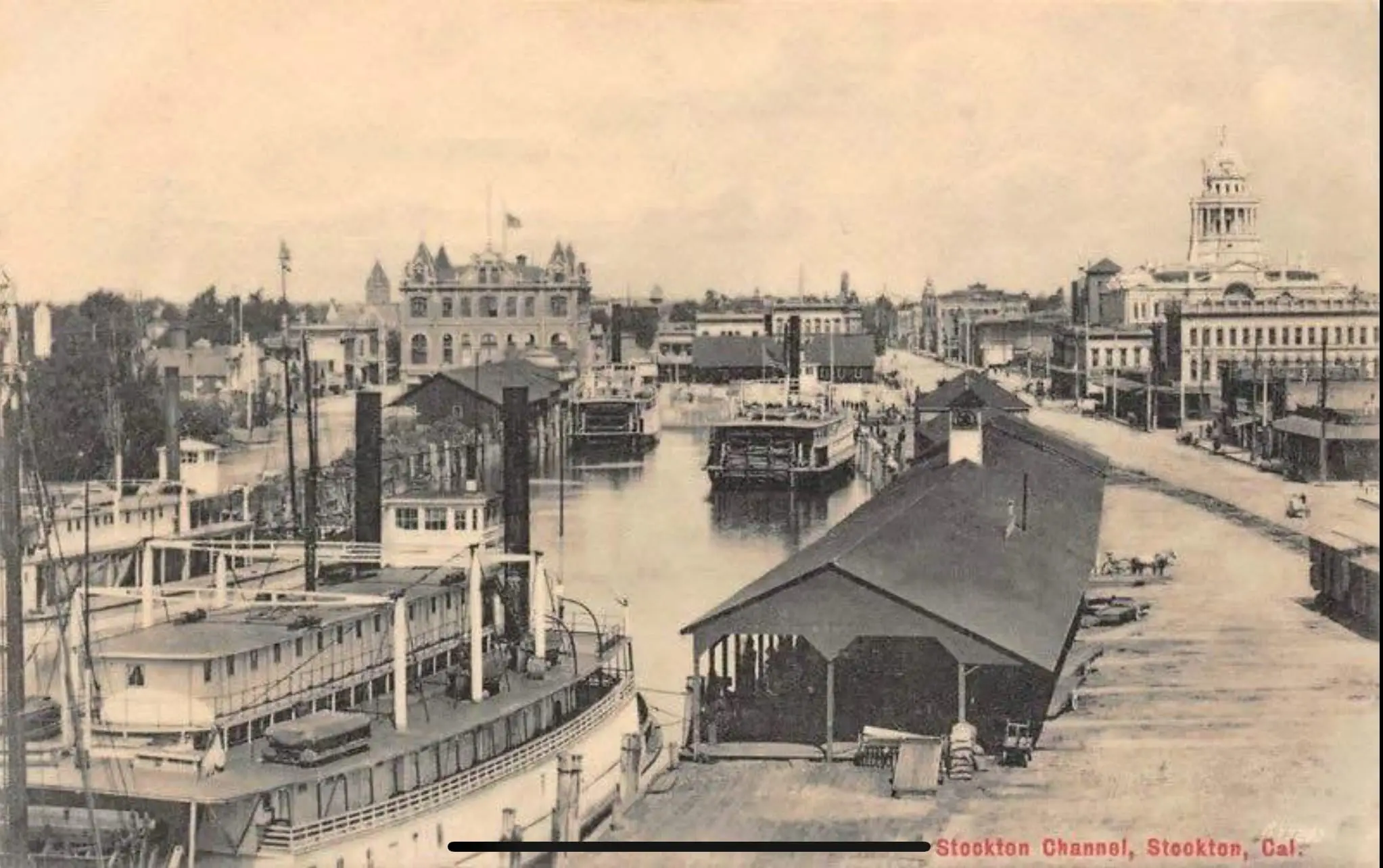Historic photograph of Stockton's downtown waterfront in the early 1900s, showing commercial docks, steamboats, and the city's bustling maritime district.