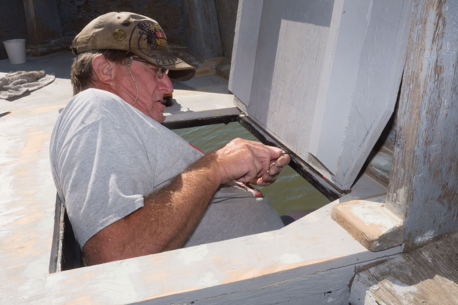 Volunteer repairing the exterior structure of the USS Lucid.