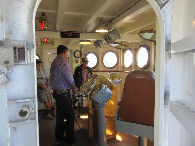 Visitor touring the restored bridge of the USS Lucid.