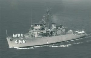 Historic photograph of the USS Lucid (MSO-458) underway at sea during her active U.S. Navy service, showing the Aggressive-class oceangoing minesweeper with her crew on deck.